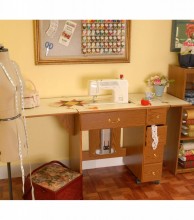 It is a small, versatile storage unit designed to sit on a table or desk. It features a louvered door and is often used to store a portable sewing machine inside or simply as general craft storage .